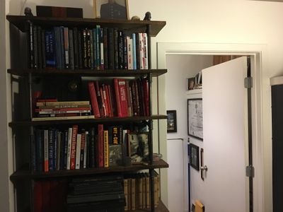 A book shelf full with books in a room