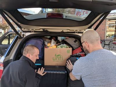 Adam Zimmermann and Alfonso Gómez-Arzola playing Tetris with luggage and groceries.