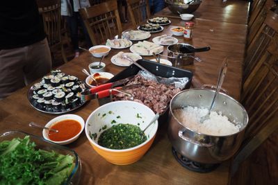 Momofuku's Bo Ssam, Steak, Teriyaki Chicken, and vegetarian Gimbap, Dak Bulgogi Chicken, Rice, Spring Rolls, Kimchi, and a side salad w/starfruit